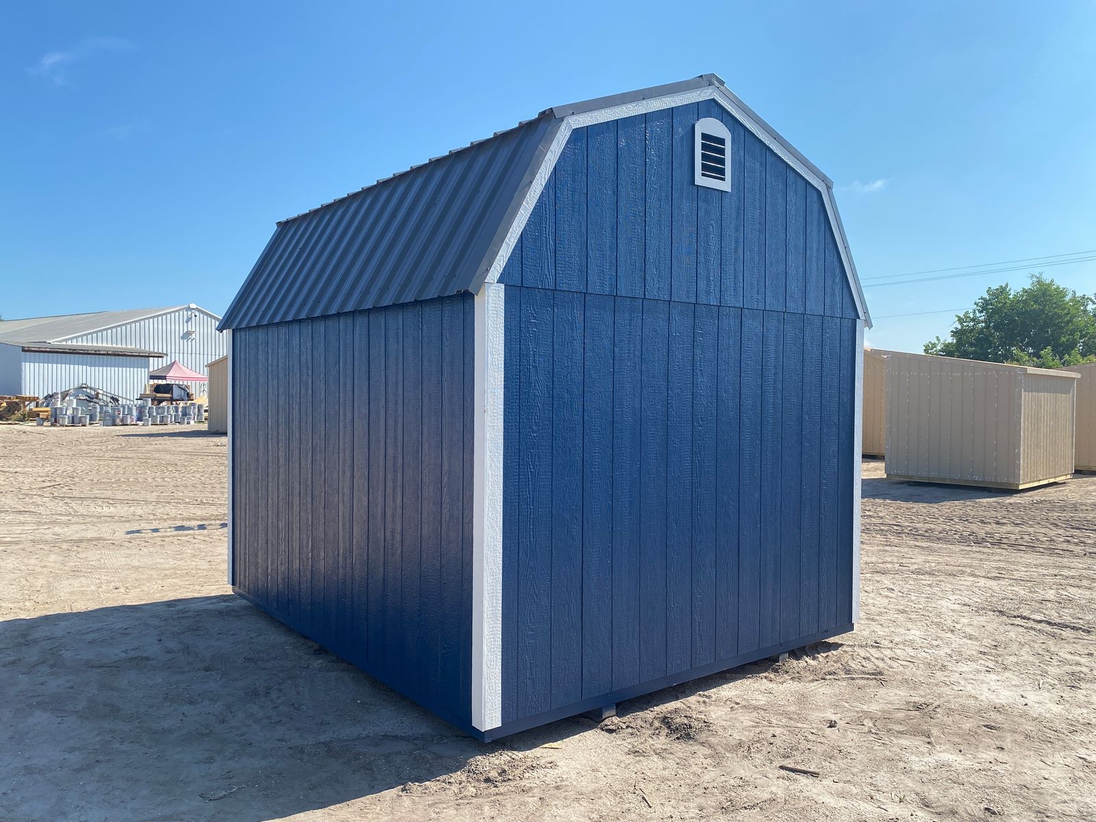 10x12 Stor-Mor Lofted Barn in Navy Blue, rear corner view with gable vent and charcoal roof