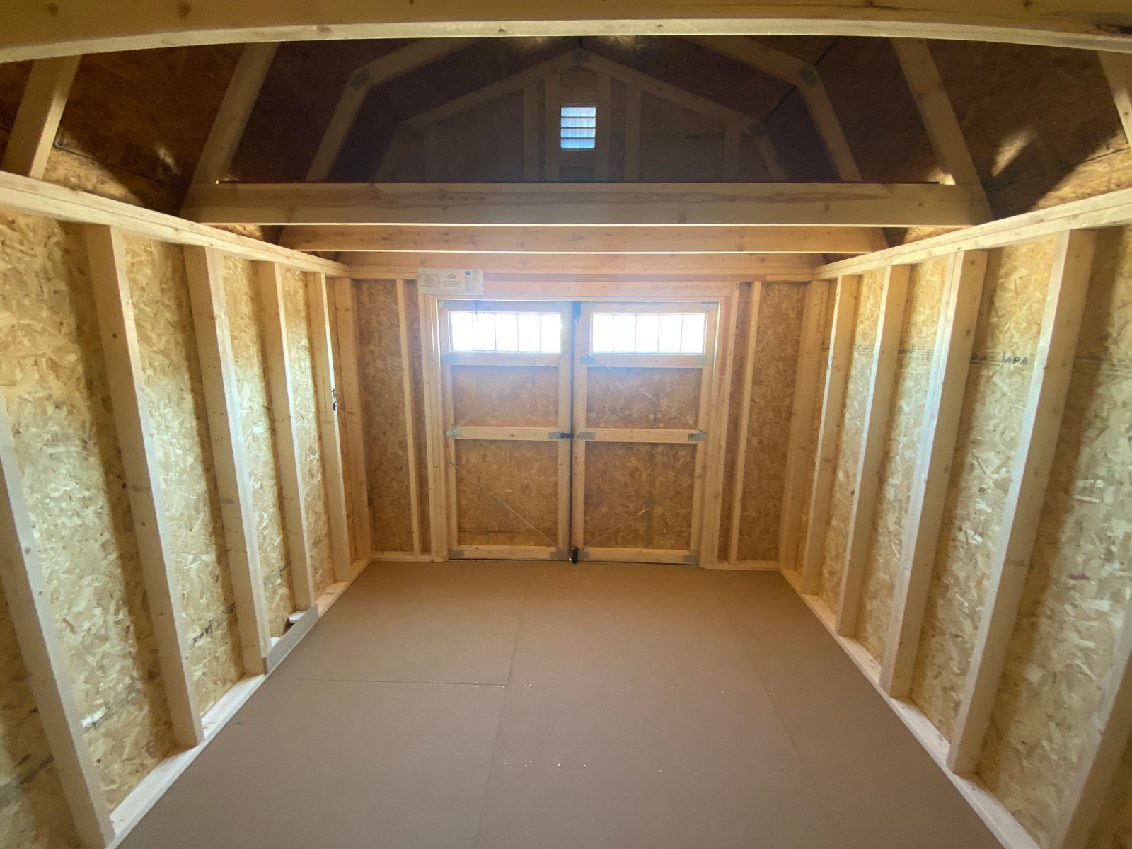 10x12 Stor-Mor Lofted Barn interior with lofts at each end, looking toward the transom doors