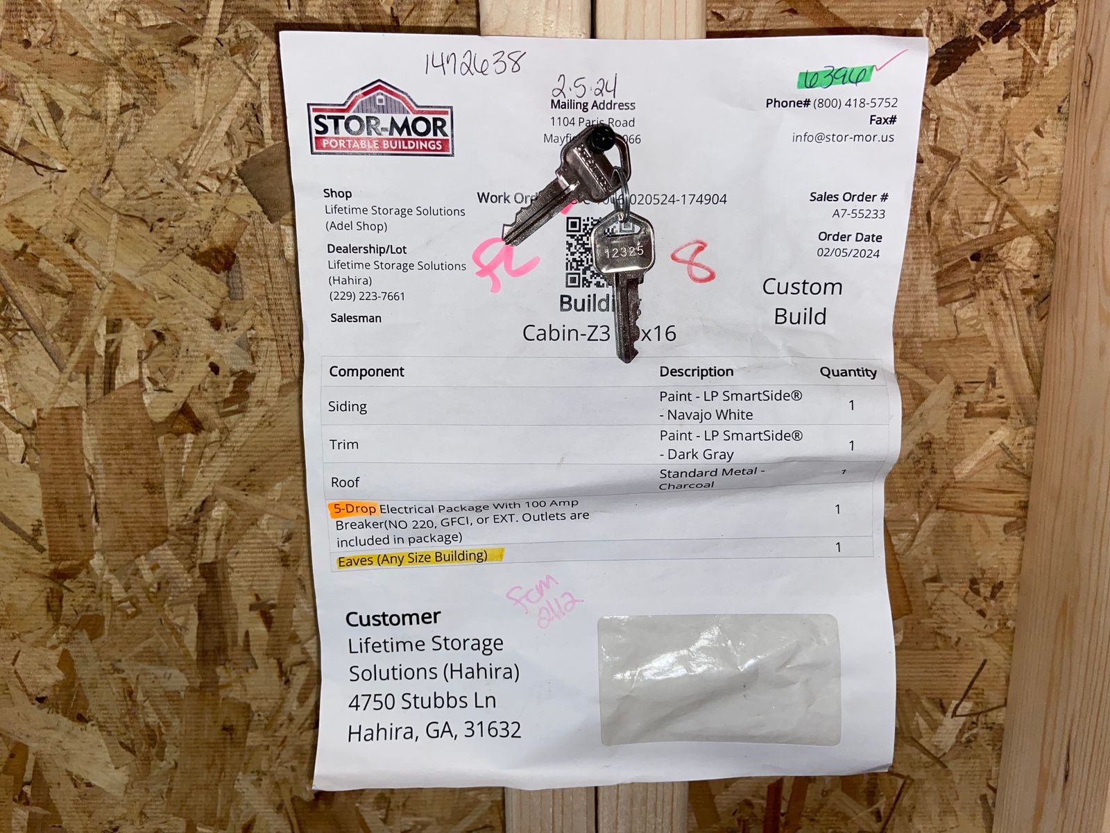 Factory work order sheet for the 10x16 Navajo White Stor-Mor cabin with keys attached