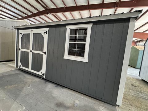 10x16 Stor-Mor Garden Shed in Dark Gray with white trim, double shop doors, a window and a Galvalume metal roof