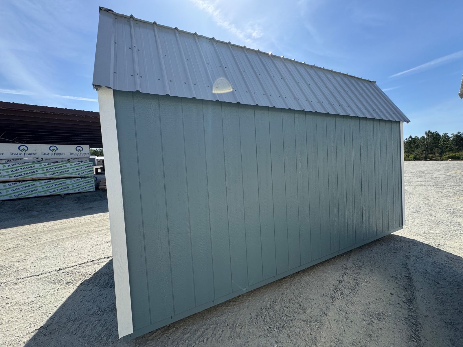 10x16 Belmont Blue Stor-Mor Lofted Barn side wall at an angle under the gray metal roof