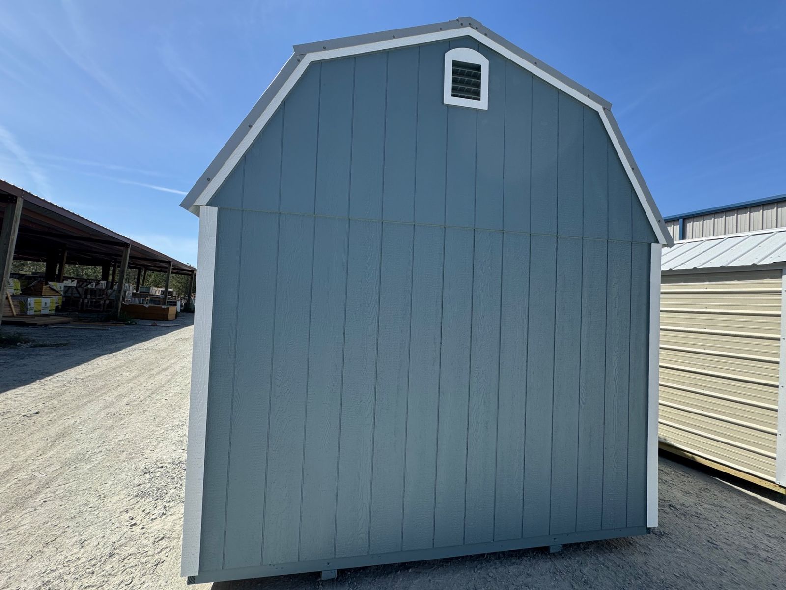 Rear gable end of the 10x16 Belmont Blue Lofted Barn with a vent and white corner trim