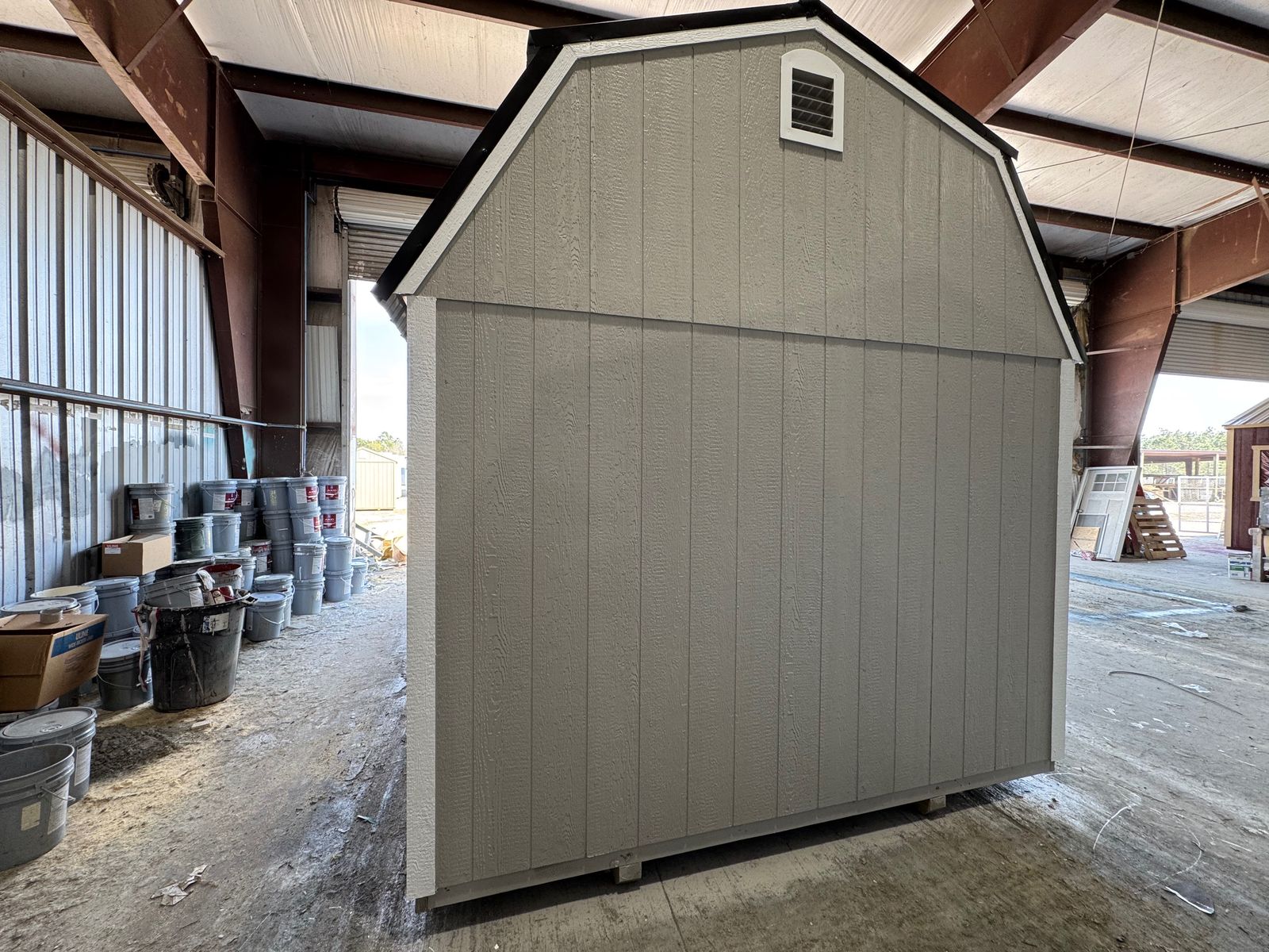 Gable end of the 10x16 Light Gray Side Lofted Barn with a vent and white corner trim