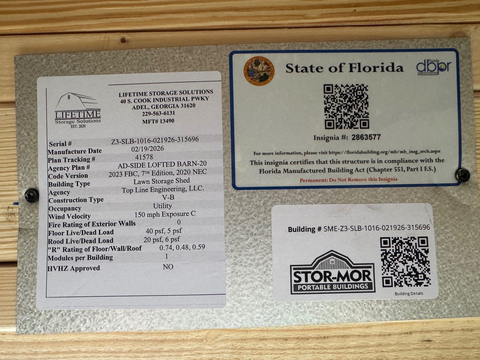 10x16 Light Gray Side Lofted Barn data plate with the State of Florida insignia and QR codes