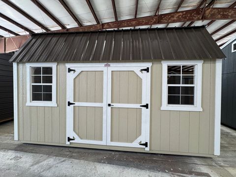 10x16 Stor-Mor Side Lofted Barn in New Holland Beige with white trim, double shop doors on the long wall and a Burnished Slate roof