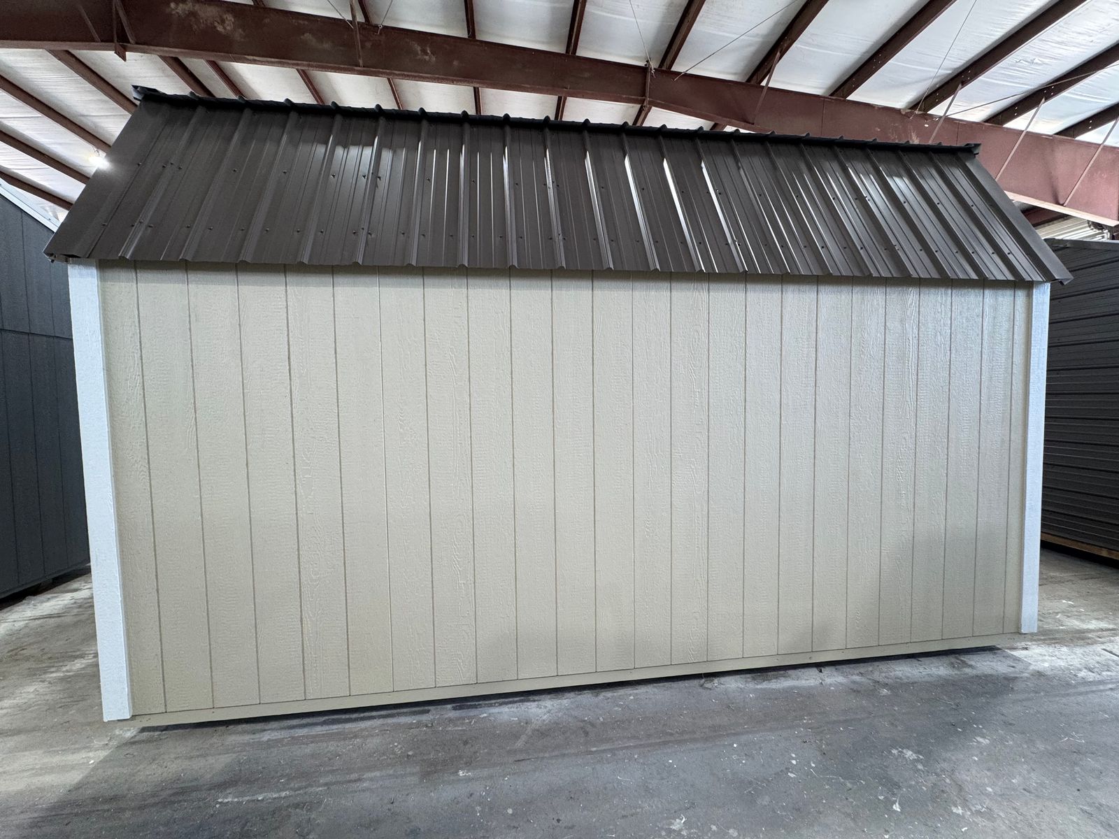 Rear long wall of the 10x16 New Holland Beige Side Lofted Barn under the Burnished Slate metal roof