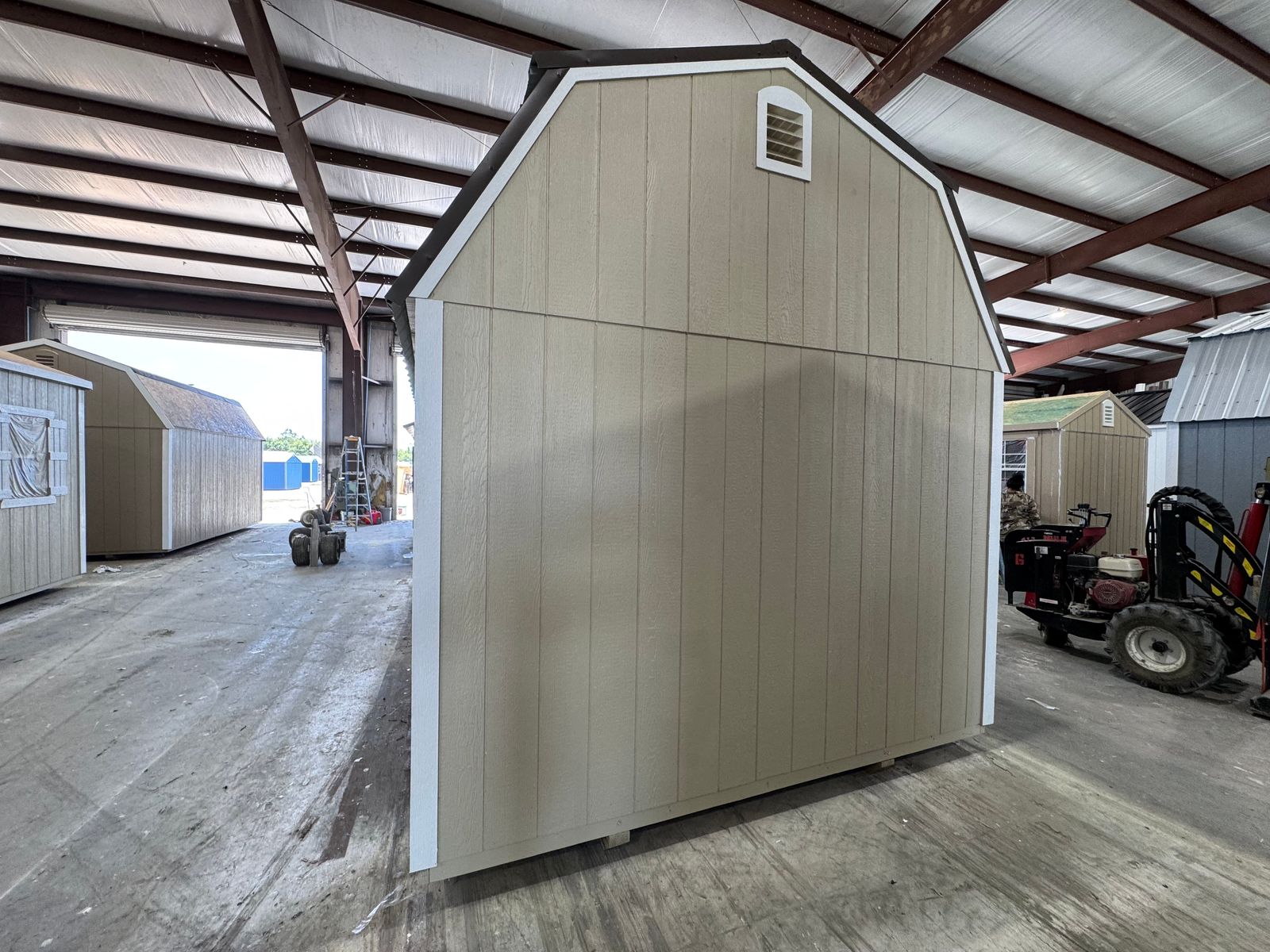 Opposite gable end of the 10x16 New Holland Beige Side Lofted Barn with a vent near the peak