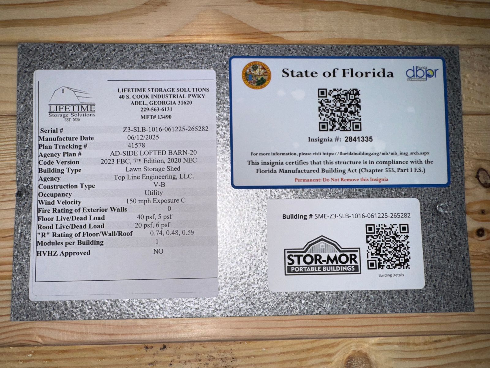 10x16 New Holland Beige Side Lofted Barn data plate with the State of Florida insignia and QR codes