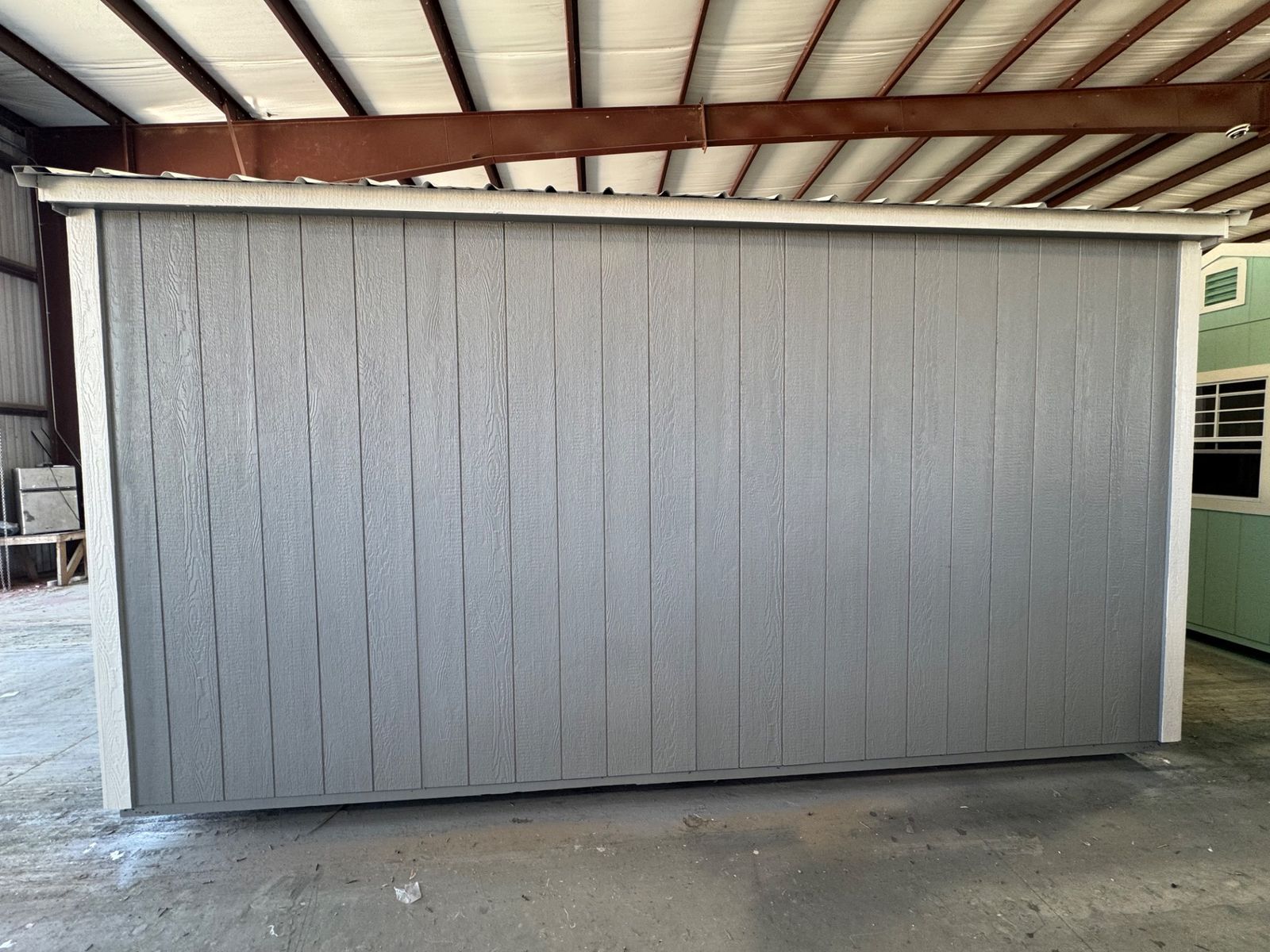 Rear long wall of the 10x16 Cape Cod Gray Side Utility with white trim and Galvalume roof edge