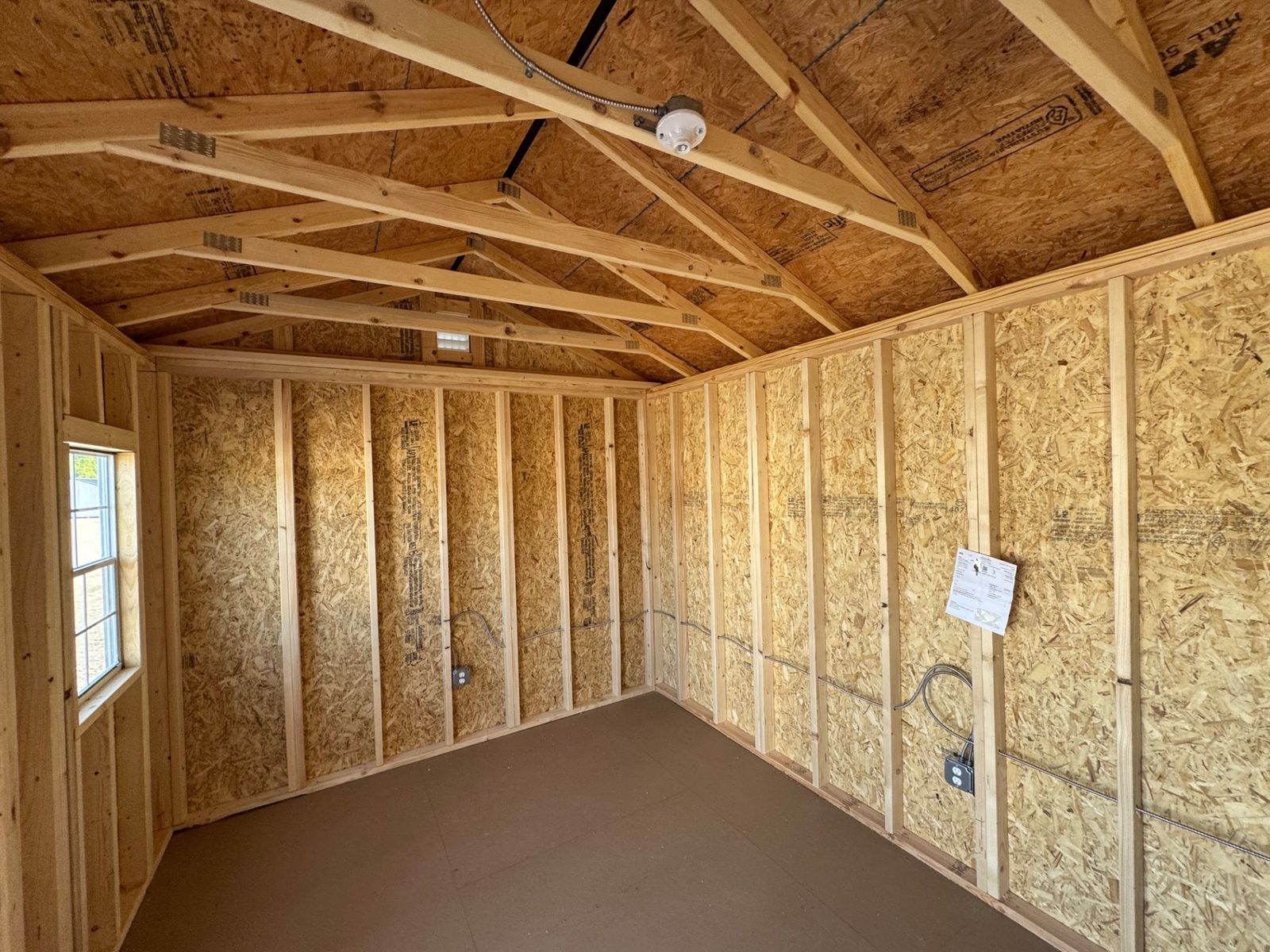 Interior of the 10x16 Cape Cod Gray Side Utility with open rafters, a window, outlets and a ceiling light