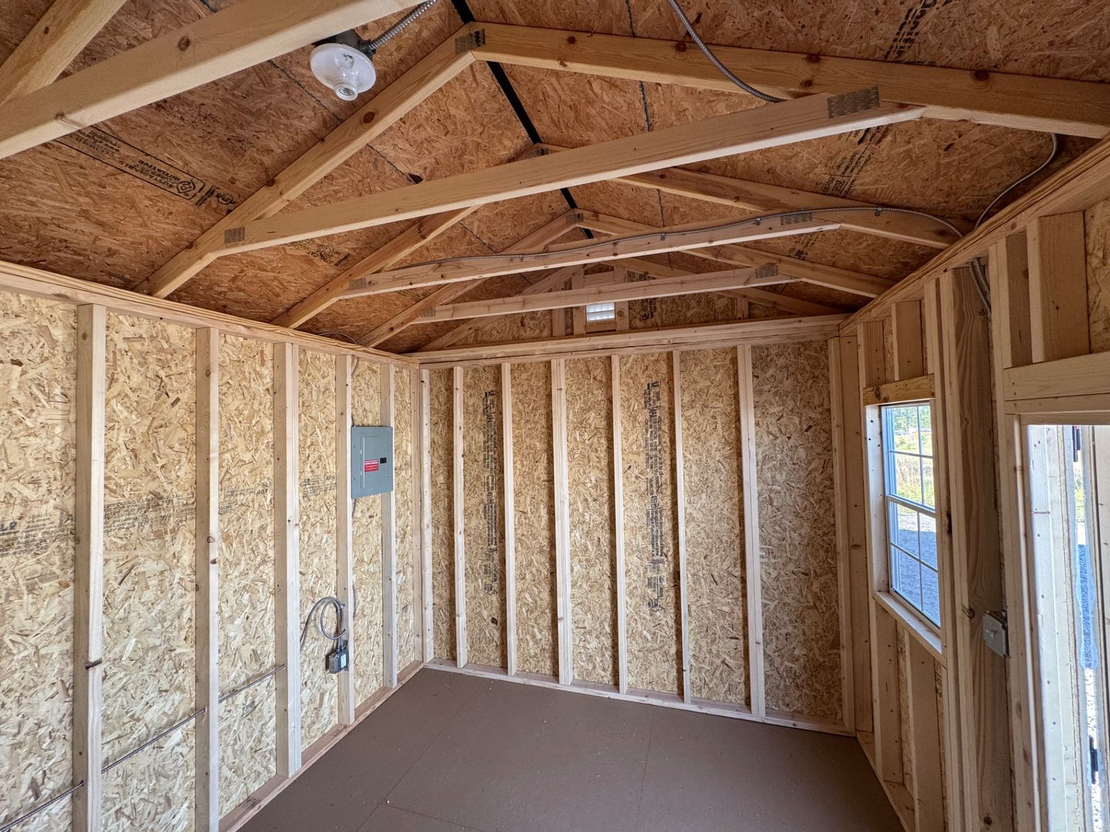 10x16 Cape Cod Gray Side Utility interior showing the 100 amp electrical panel on the end wall and windows