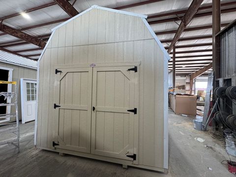 10x16 Stor-Mor Tru-Valu Lofted Barn in New Holland Beige with roof-matched trim, double shop doors and a white gambrel roof