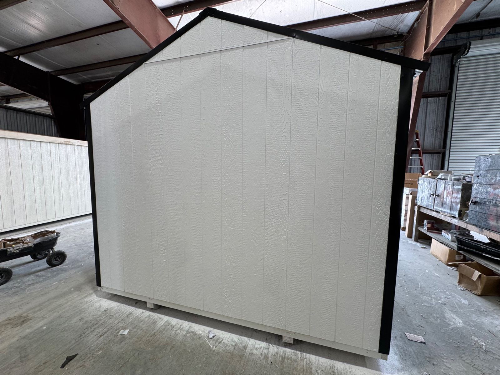 10x16 Stor-Mor Tru-Valu Utility in white, gable end with black trim, angled view