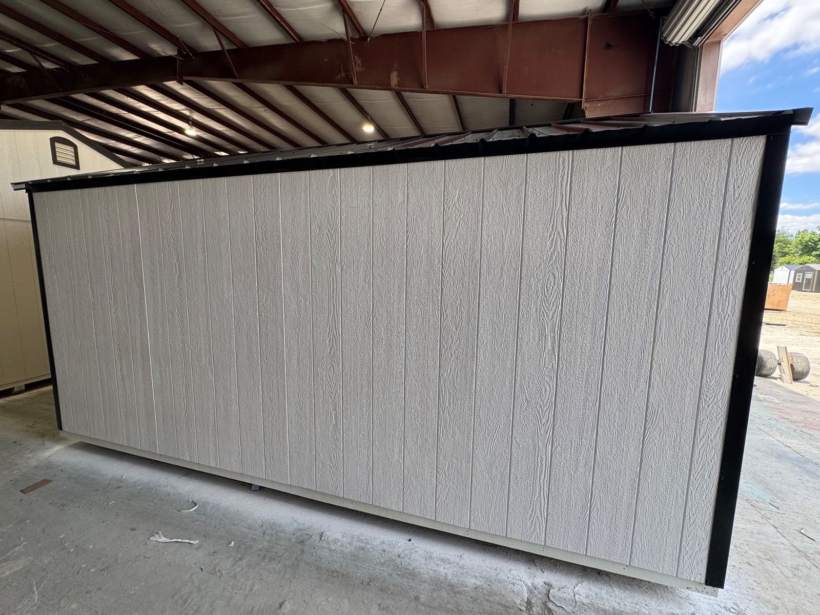 10x16 Stor-Mor Tru-Valu Utility in white, rear wall with black roof edge, angled view