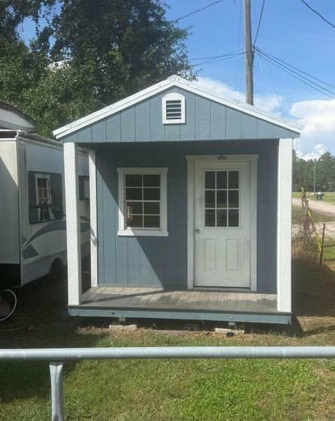 Pre-owned 10x20 Stor-Mor cabin in Belmont Blue with white trim and a Galvalume metal roof
