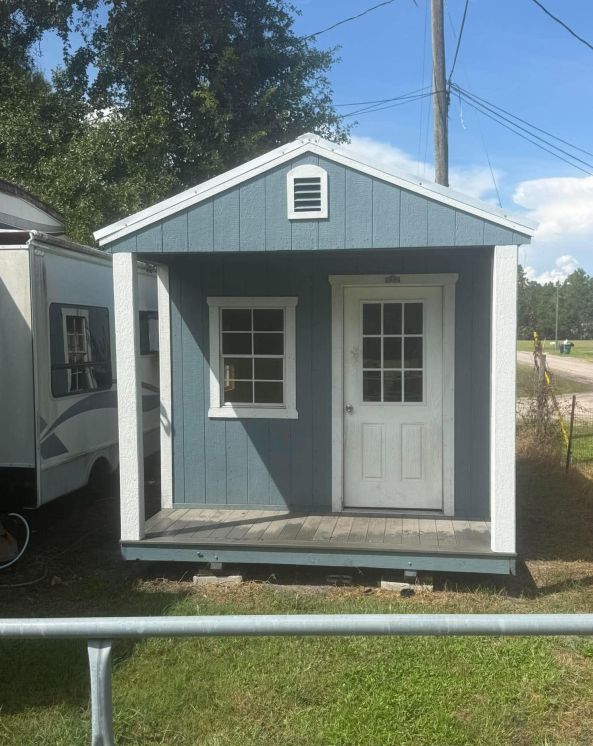 Pre-owned 10x20 Stor-Mor cabin in Belmont Blue with white trim and a Galvalume metal roof