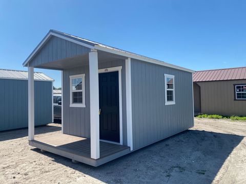 10x20 Stor-Mor cabin in Cape Cod Gray with white trim, a painted accent door and a charcoal metal roof