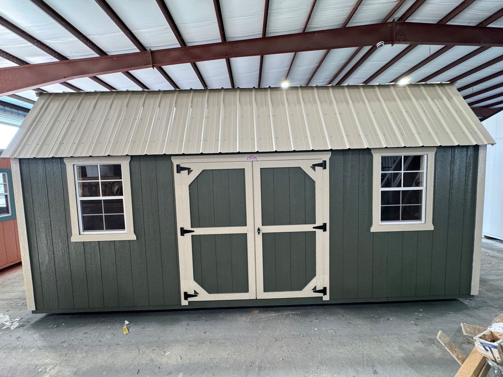 10x20 Stor-Mor Side Lofted Barn in Avocado with New Holland Beige trim, double shop doors on the long wall and a Light Stone roof