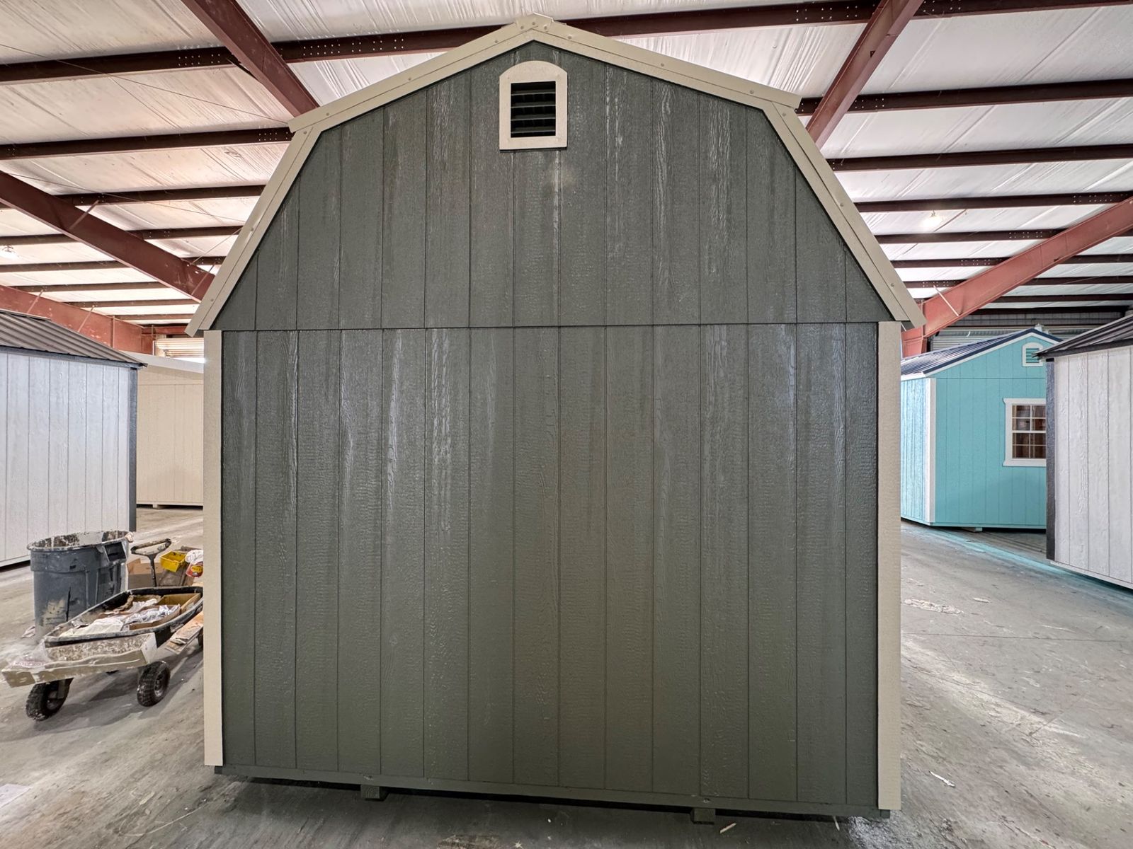 Gable end of the 10x20 Avocado Side Lofted Barn with a vent and New Holland Beige corner trim