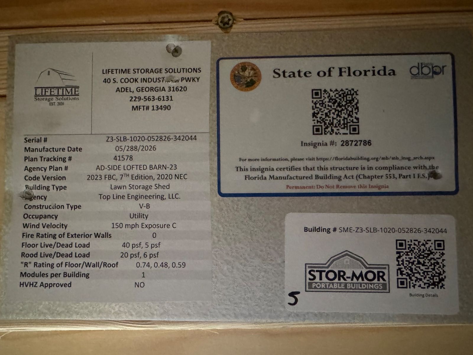 10x20 Avocado Side Lofted Barn data plate with the State of Florida insignia and QR codes