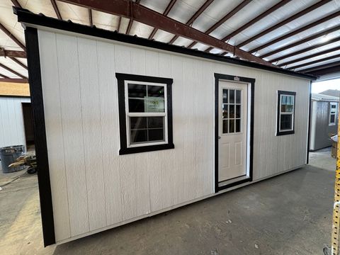 10x20 backyard office, white Stor-Mor Side Utility with black trim, a 9-lite door between two thermal windows and a black roof