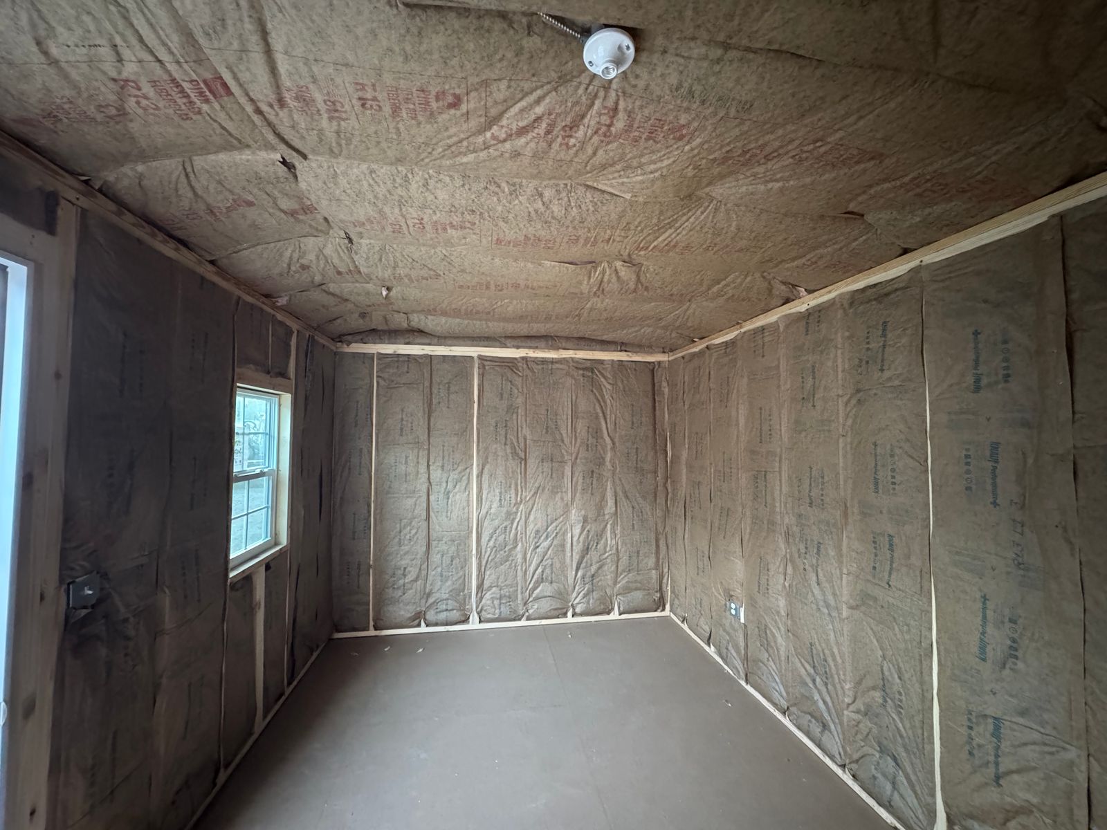 10x20 backyard office interior facing the window end, with ceiling light