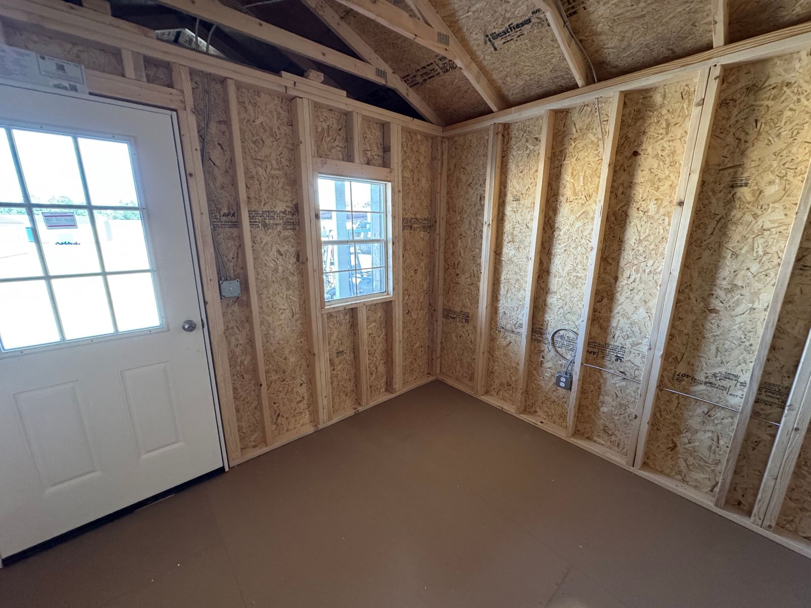 12x24 New Holland Beige Stor-Mor cabin interior corner with 9-lite door and window