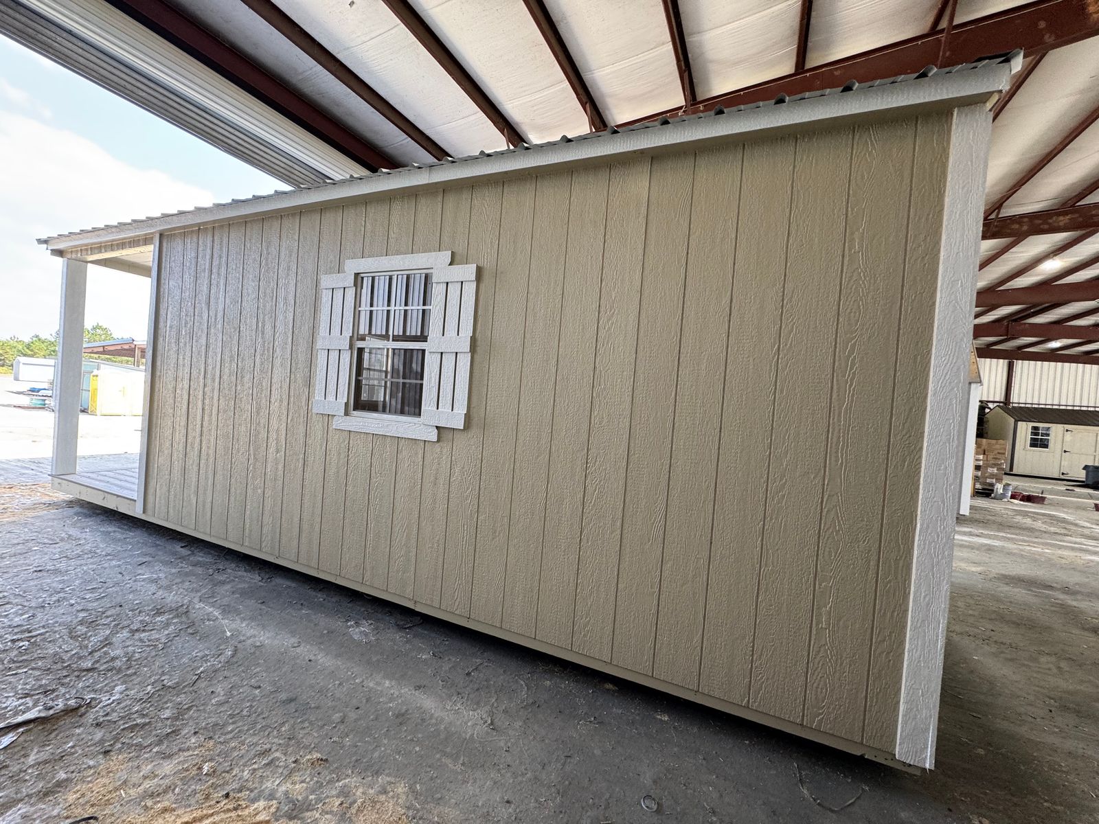 12x24 New Holland Beige Stor-Mor cabin side wall with shuttered window and porch post