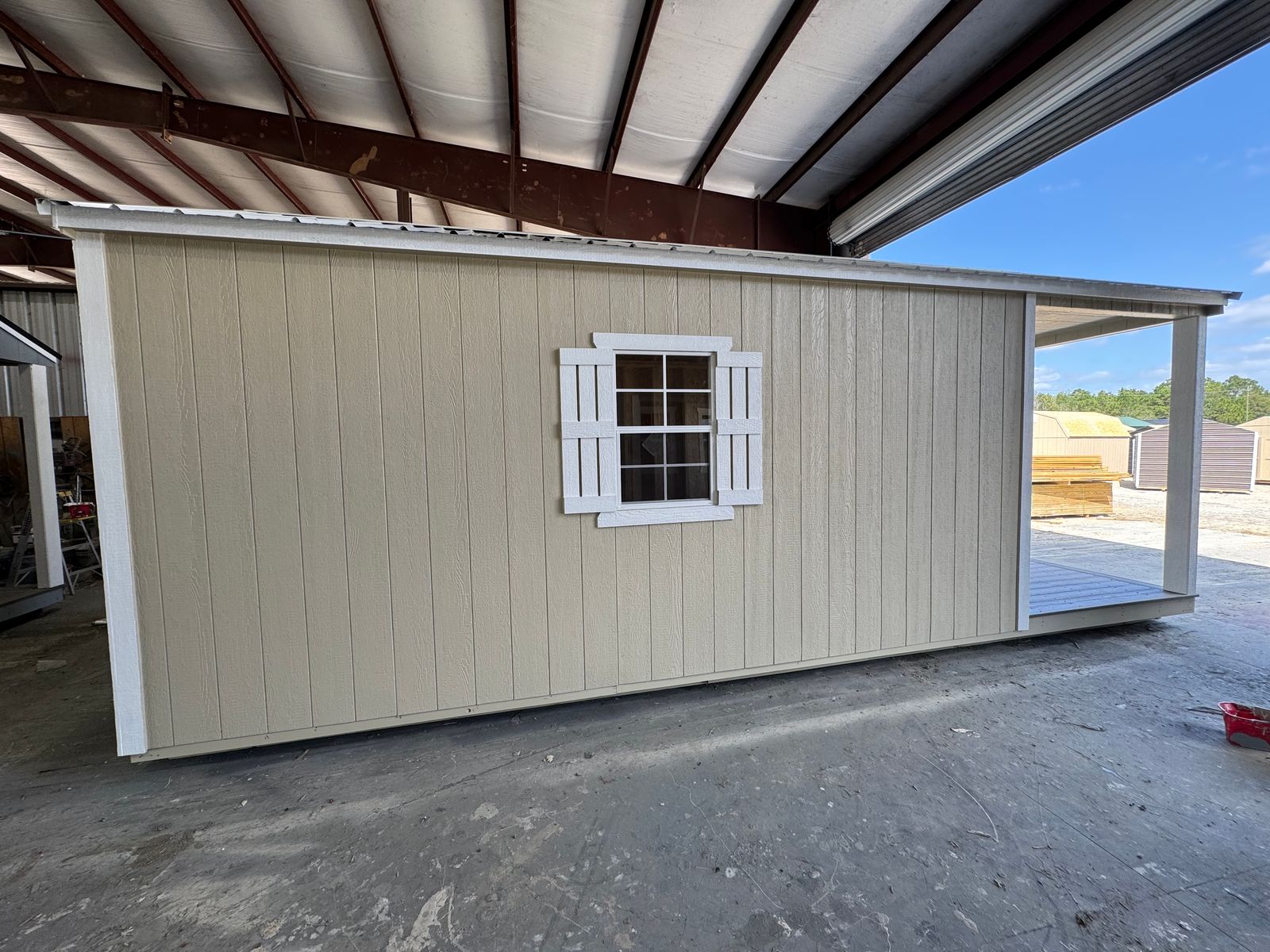 12x24 New Holland Beige Stor-Mor cabin opposite side wall with shuttered window