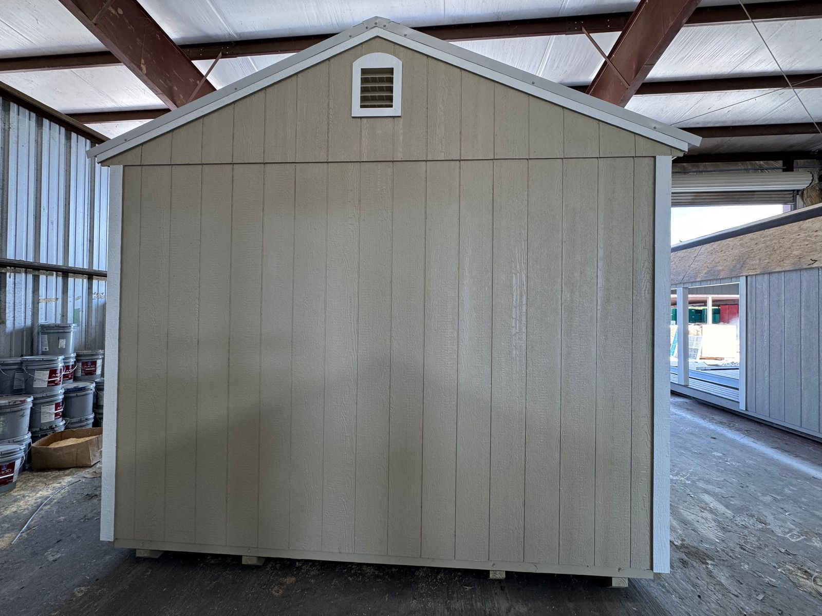 12x24 New Holland Beige Stor-Mor cabin rear gable end with vent and white trim