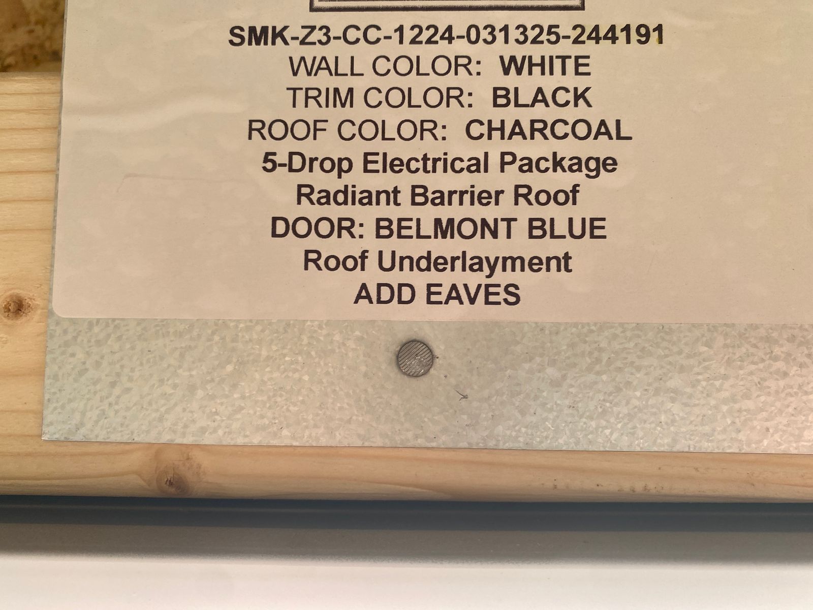 12x24 white Stor-Mor Center Cabin build label listing colors, radiant barrier roof and eaves