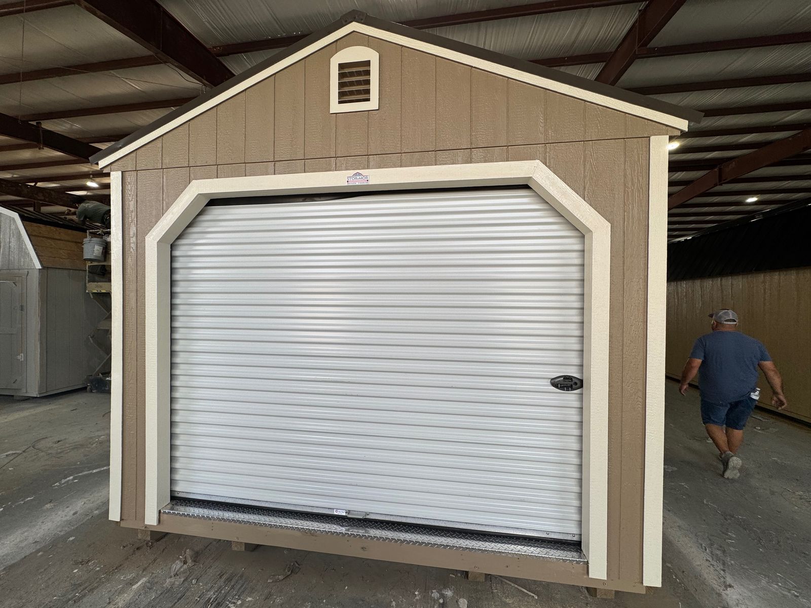 12x24 Buckskin Stor-Mor garage, gable end with 9 ft white roll-up garage door and vent