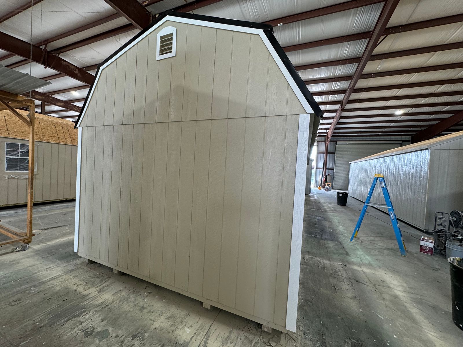 12x36 New Holland Beige Stor-Mor Deluxe Lofted Barn Cabin, rear gambrel end with vent