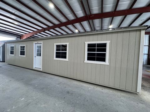 12x40 Stor-Mor Side Utility building in New Holland Beige with Navajo White trim, a 9-lite door, windows and a Burnished Slate roof
