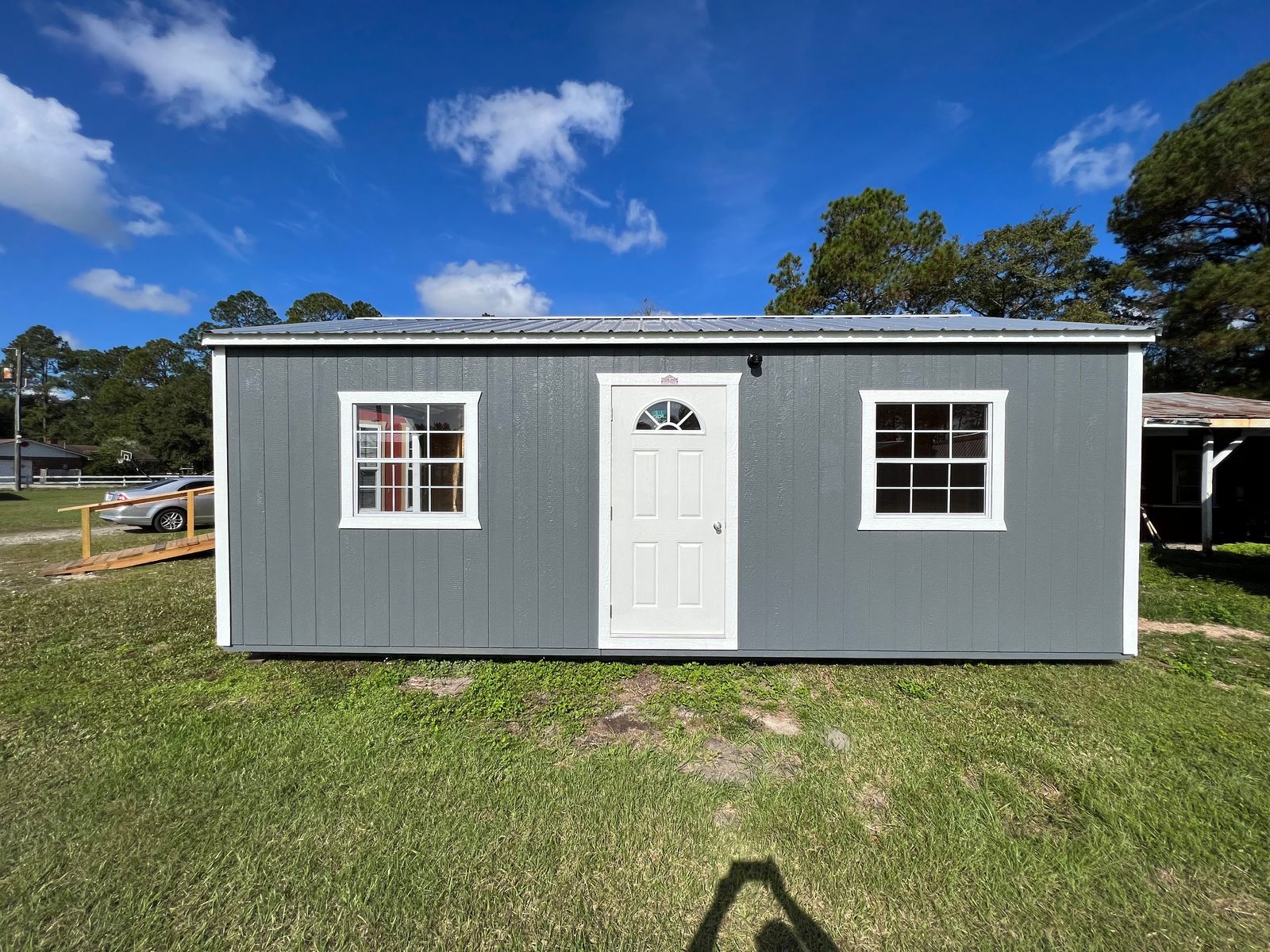 14x24 Dark Gray Stor-Mor garage side with white entry door between two white-grid windows