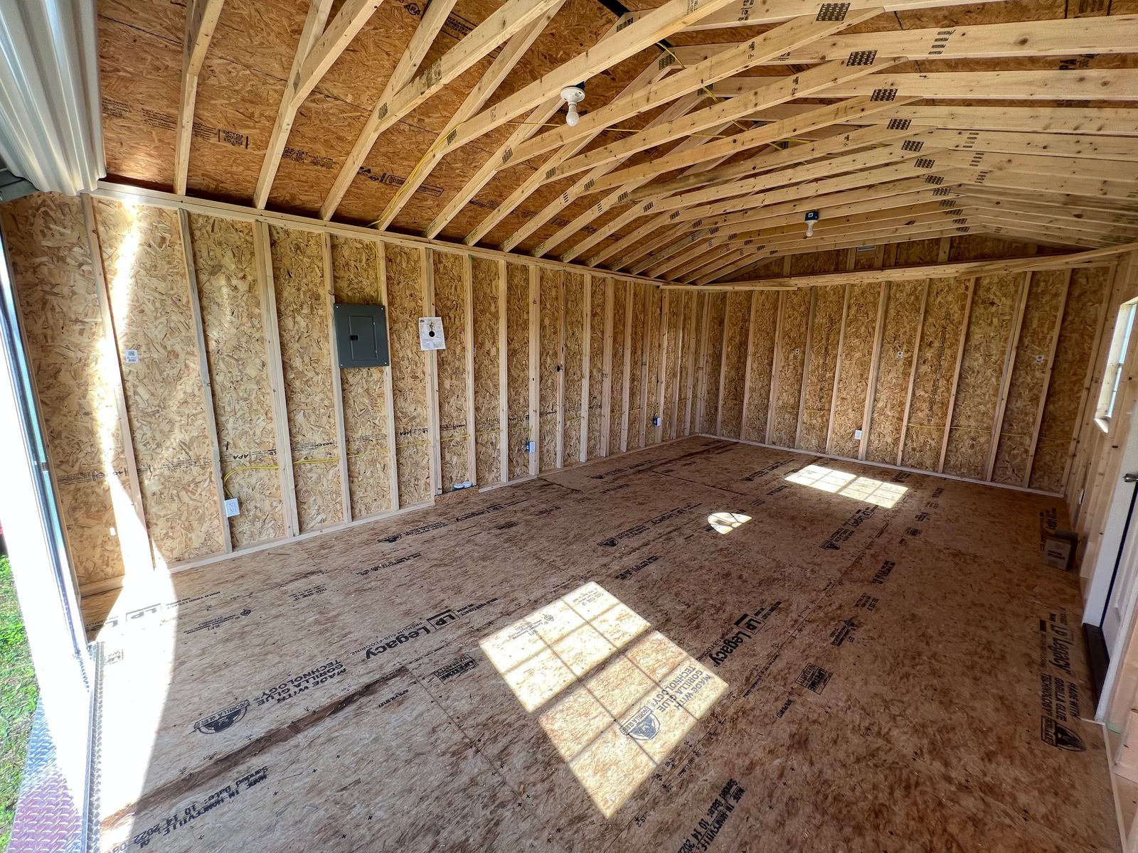 14x24 Dark Gray Stor-Mor garage interior with electrical panel, outlets and open framing