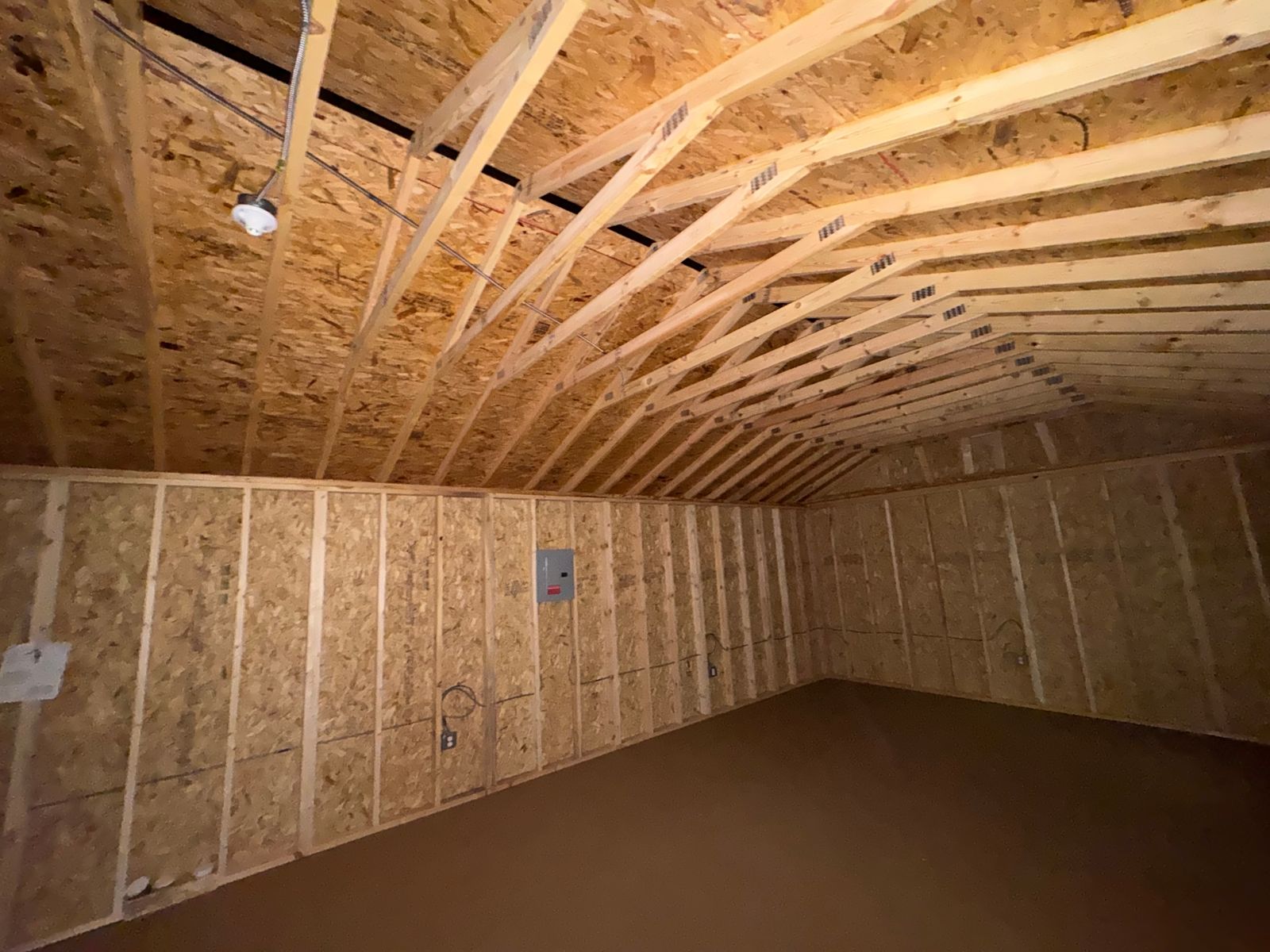 16x44 Stor-Mor Side Utility workshop interior with electrical panel and open rafters