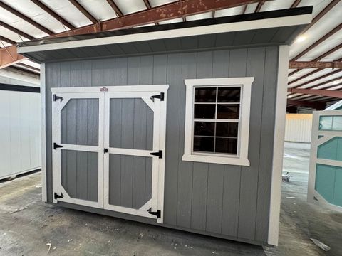 8x12 Stor-Mor Cottage Shed in Cape Cod Gray with white trim, double shop doors and a black metal roof