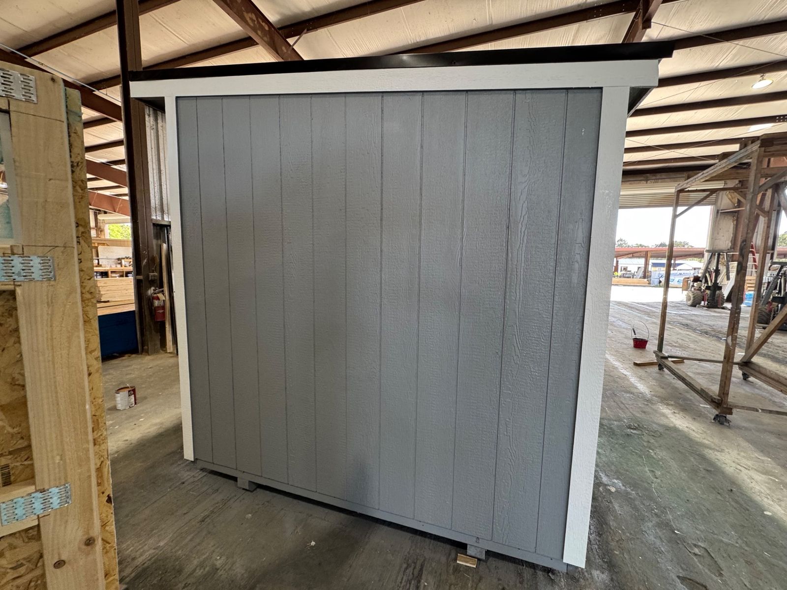 8x12 Stor-Mor Cottage Shed in Cape Cod Gray, side wall with white trim, angled view