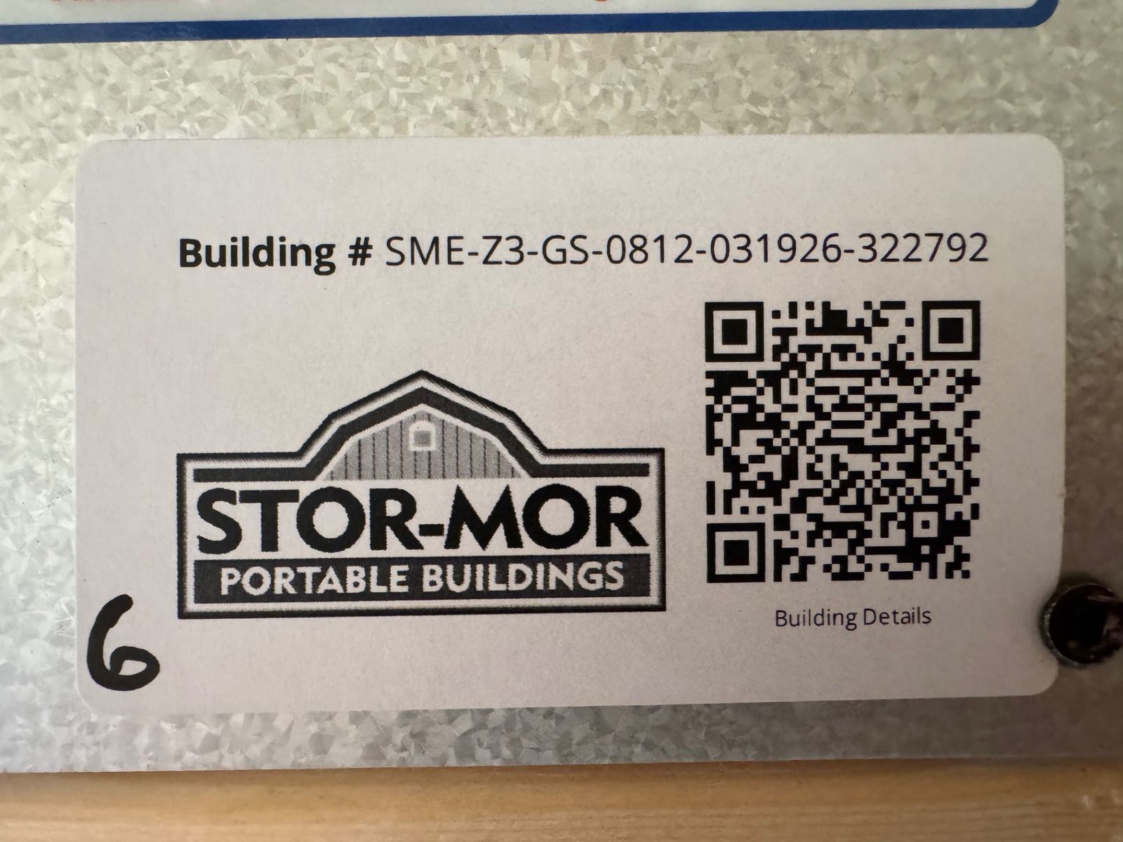 8x12 Stor-Mor Garden Shed building number label with QR code, close-up