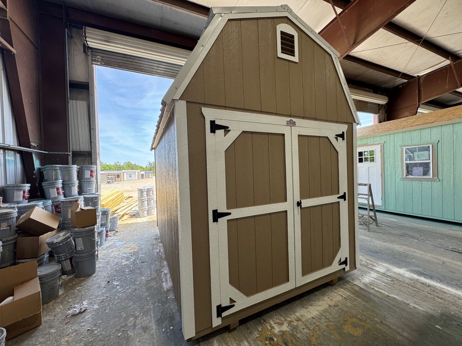 8x12 Stor-Mor Lofted Barn in Buckskin with white trim, double shop doors and a white gambrel roof