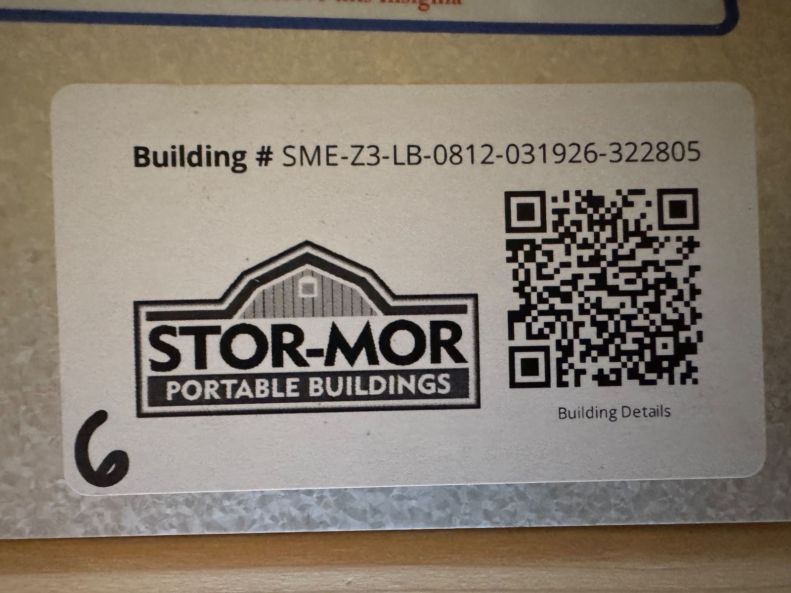 8x12 Stor-Mor Lofted Barn building number label with QR code, close-up