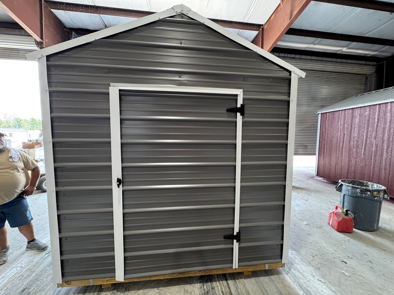 8x12 Stor-Mor Metal Utility building in charcoal with white trim and a white metal roof