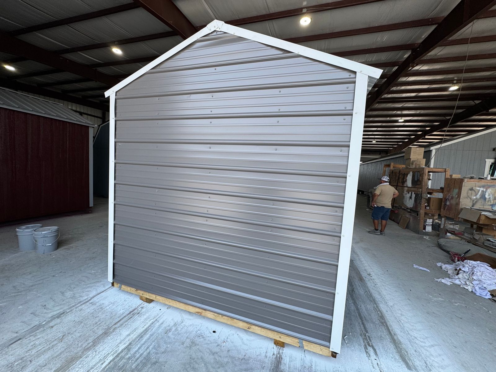 8x12 Stor-Mor Metal Utility in charcoal, rear corner view of the gable end with white trim
