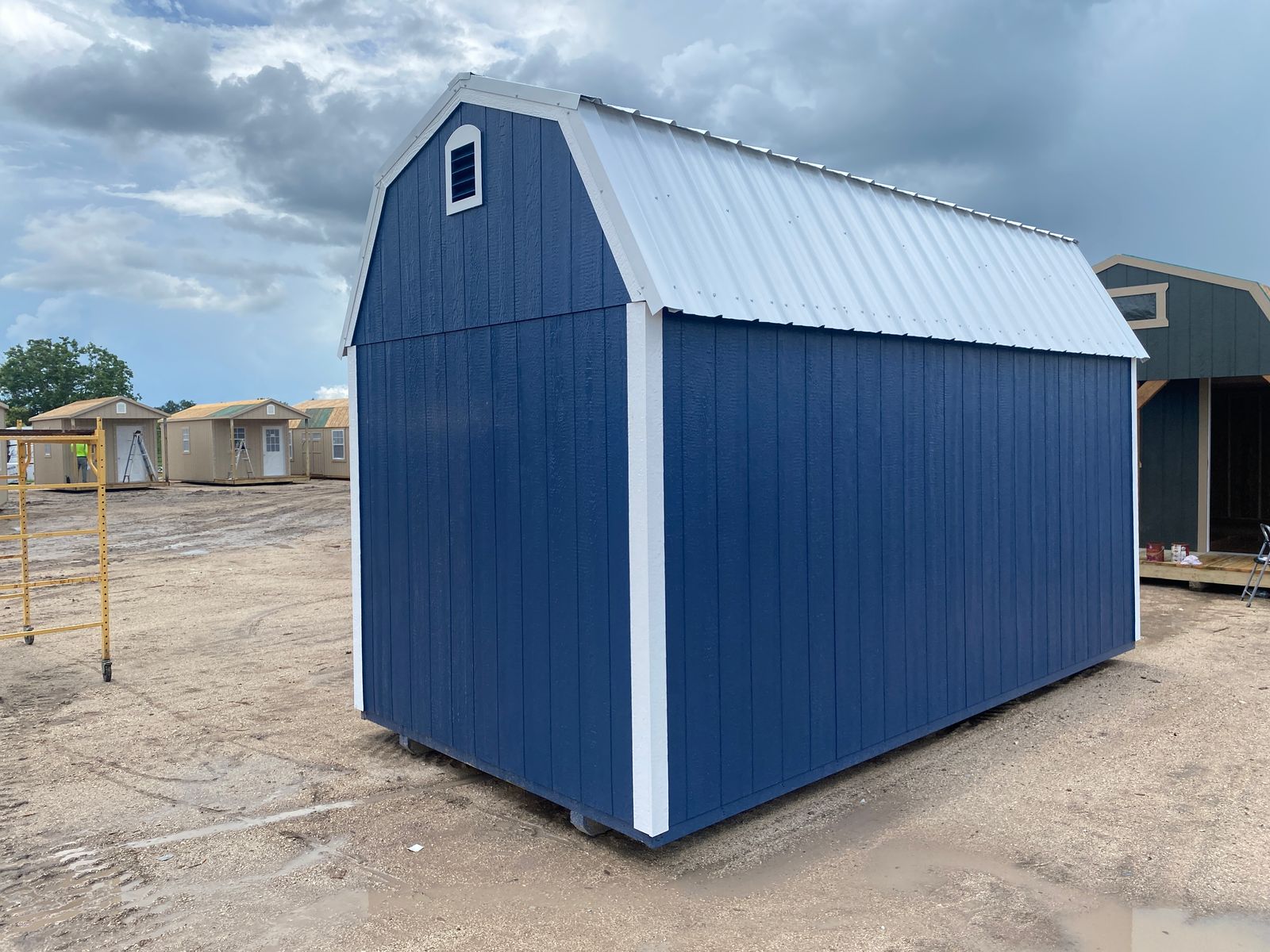 8x16 Navy Blue Stor-Mor Lofted Barn rear corner view showing the gable vent, side wall and white metal roof
