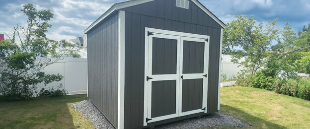 Utility shed with gable roof and double wooden doors